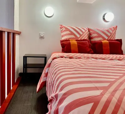 a bedroom with a bed with red and white stripes at Red Calmette in Cannes