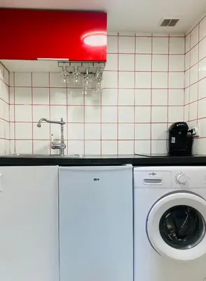 a kitchen with a washing machine and a red light at Red Calmette in Cannes