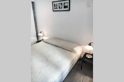 a bed in a room with two lamps on a table at C038-Elegant apt a few steps from beaches - Le Suquet in Cannes