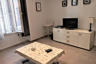 a living room with a coffee table and a tv at C038-Elegant apt a few steps from beaches - Le Suquet in Cannes