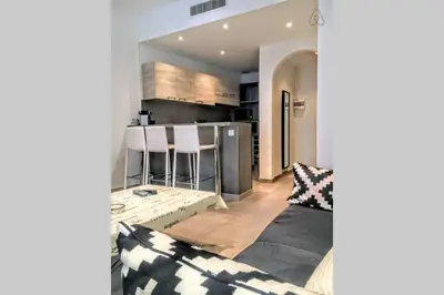 a living room with a couch and a kitchen at C038-Elegant apt a few steps from beaches - Le Suquet in Cannes
