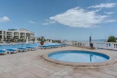 a swimming pool with lounge chairs and a resort at Un Studio de Charme Vue Mer & Piscine d'Exception in Cannes