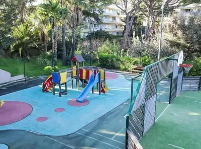 a playground in a park with a slide at Un Studio de Charme Vue Mer & Piscine d'Exception in Cannes