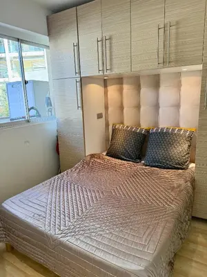 a bedroom with a large bed with a large headboard at Apartment 2 pièces Cannes Centre in Cannes