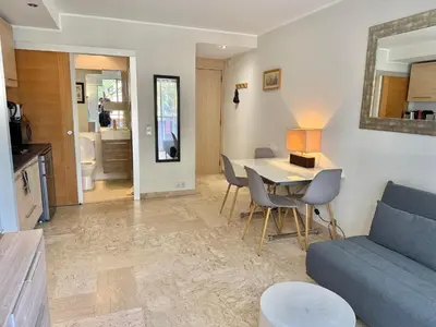 a living room with a blue couch and a table at Apartment 2 pièces Cannes Centre in Cannes