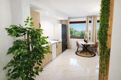 a kitchen with a small table and a sink at Studio design - 5 min à pied du Palais & plages in Cannes