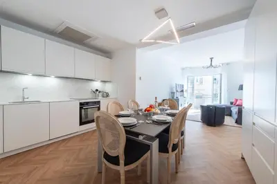 a kitchen and dining room with a table and chairs at 3-Br apartment in the Golden Square in Cannes