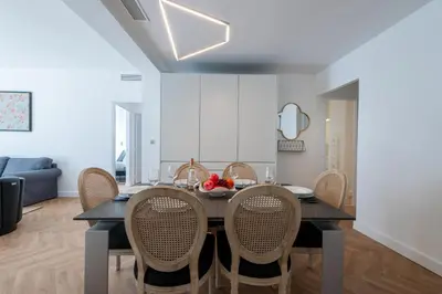 a dining room with a table and chairs at 3-Br apartment in the Golden Square in Cannes