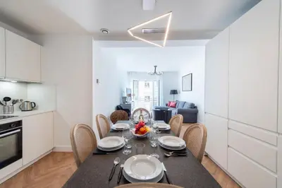 a kitchen and dining room with a table and chairs at 3-Br apartment in the Golden Square in Cannes