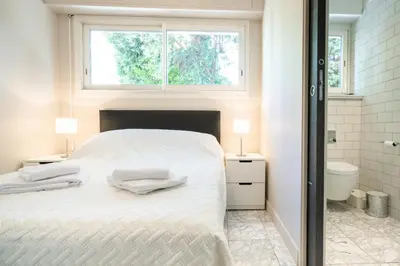 a bedroom with a white bed and a window at 2-Bedroom Apartment Pointe Croisette Peaceful Walk to the Beach in Cannes