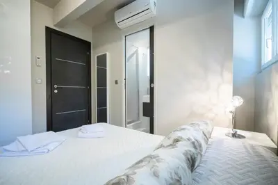 a bedroom with a large white bed and a window at 2-Bedroom Apartment Pointe Croisette Peaceful Walk to the Beach in Cannes