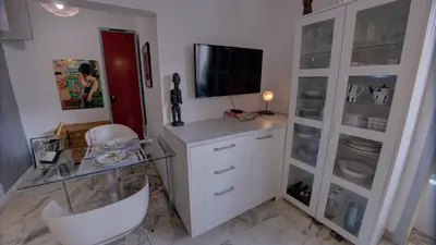 a room with a desk with a tv on top of it at Les Tambourins Studio 19 - 3 étoiles in Cannes