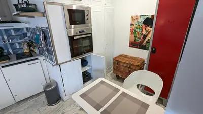 a small kitchen with a toilet and a refrigerator at Les Tambourins Studio 19 - 3 étoiles in Cannes