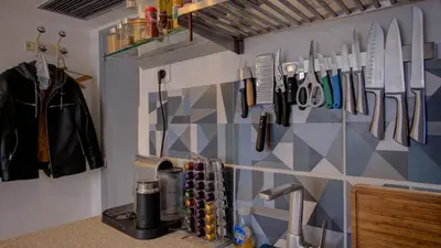 a kitchen with a wall with knives and utensils at Les Tambourins Studio 19 - 3 étoiles in Cannes