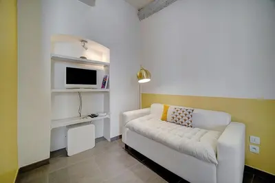 a living room with a white couch and a tv at Joli Studio VIEUX PORT-BAS SUQUET A0B065 in Cannes