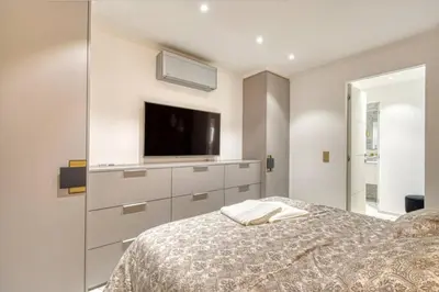 a bedroom with a bed with a tv on the wall at Somptueux logement,Cannes Croisette,4 Étoiles**** in Cannes