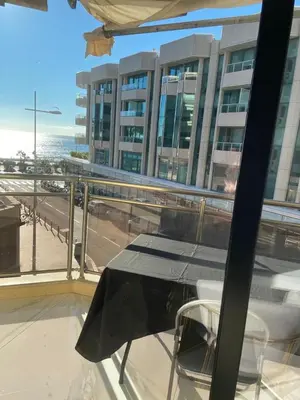a table and chairs on a balcony with a building at Somptueux logement,Cannes Croisette,4 Étoiles**** in Cannes