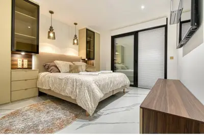 a bedroom with a bed and a dresser and a tv at Somptueux logement,Cannes Croisette,4 Étoiles**** in Cannes