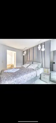 a bedroom with a large bed and two lights at Somptueux logement,Cannes Croisette,4 Étoiles**** in Cannes