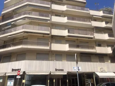 a large apartment building with a street sign in front of it at Somptueux logement,Cannes Croisette,4 Étoiles**** in Cannes