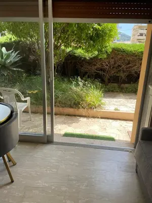 an open sliding glass door with a view of a patio at NICE FLAT WITH GARDENS Limites cannes juste 10 MNS CROISETT in Le Cannet