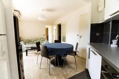 a kitchen and dining room with a table and chairs at NICE FLAT WITH GARDENS Limites cannes juste 10 MNS CROISETT in Le Cannet