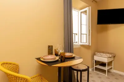 a small table in a room with a window at Le Saint Victor Coeur de Cannes in Cannes
