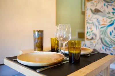 a table with two plates and a wine glass at Le Saint Victor Coeur de Cannes in Cannes