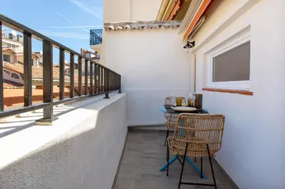 a balcony with two chairs and a table at Le Saint Victor Coeur de Cannes in Cannes