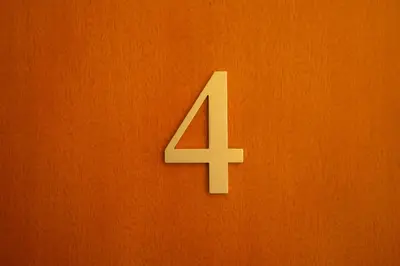 a white number four on an orange wall at Le Saint Victor Coeur de Cannes in Cannes
