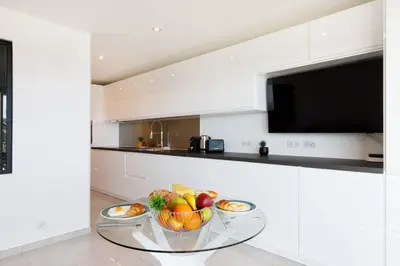 a kitchen with two bowls of fruit on a glass table at Fettolina in Cannes