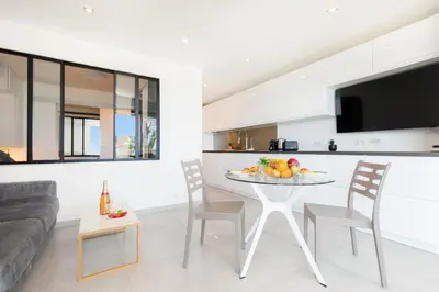 a kitchen and living room with a table and chairs at Fettolina in Cannes