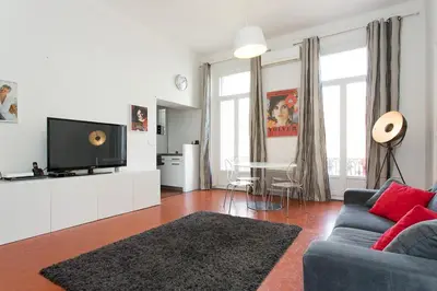 a living room with a blue couch and a tv at 1 bedroom appartement Cannes (Carnot) in Cannes