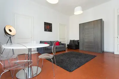 a living room with a couch and a table and chairs at 1 bedroom appartement Cannes (Carnot) in Cannes