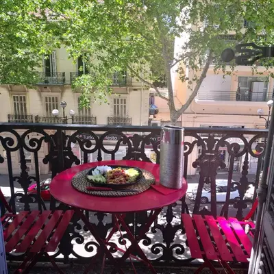 a table with a plate of food on a balcony at 1 bedroom appartement Cannes (Carnot) in Cannes