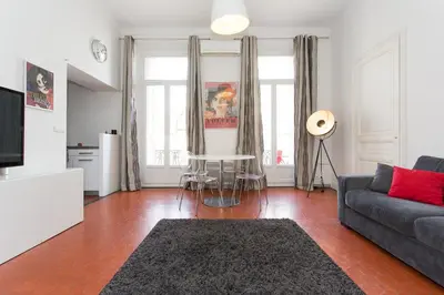 a living room with a couch and a table at 1 bedroom appartement Cannes (Carnot) in Cannes