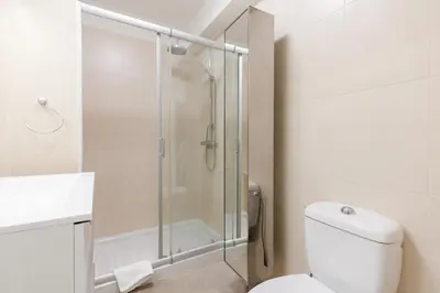 a bathroom with a shower and a toilet and a sink at Phoenix YourHostHelper in Cannes