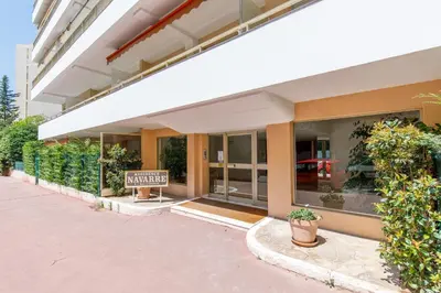 a building with a sign in front of it at Phoenix YourHostHelper in Cannes