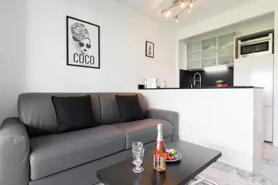 a living room with a couch and a table at Phoenix YourHostHelper in Cannes