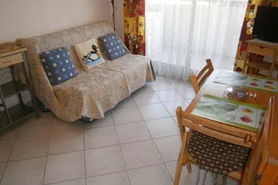 a living room with a couch and a table at Comfortable Flat With Balcony Cannes City Centre in Cannes