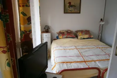 a bedroom with a bed and a flat screen tv at Comfortable Flat With Balcony Cannes City Centre in Cannes