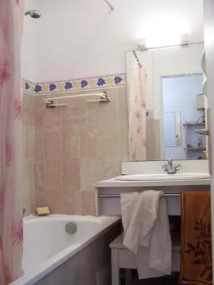 a bathroom with a tub and a sink and a mirror at Comfortable Flat With Balcony Cannes City Centre in Cannes