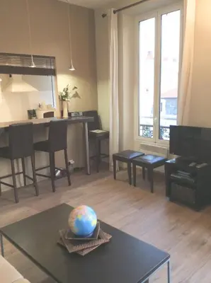 a living room with a table with a globe on it at Lecerf apartment in Cannes