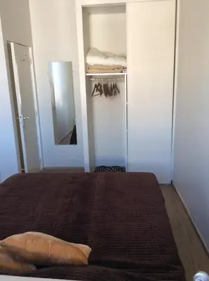 a small bedroom with a bed and a mirror at Lecerf apartment in Cannes