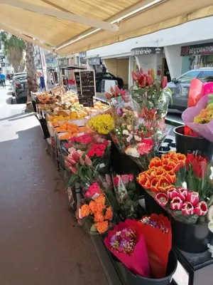 a market with many different types of flowers on display at Lecerf apartment in Cannes
