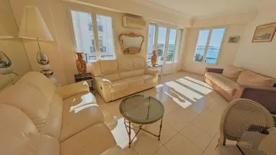 a living room with two couches and a table at Ref ILES - Palmes d'Or Properties in Cannes