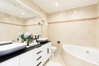 a bathroom with two sinks and a tub and a toilet at Suite Riviera - Sea View - Clim - 50M Plage - Residence de standing - Spacieux 180 M2 - Parking in Cannes