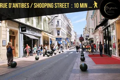 a city street with people walking down the street at Suite Riviera - Sea View - Clim - 50M Plage - Residence de standing - Spacieux 180 M2 - Parking in Cannes