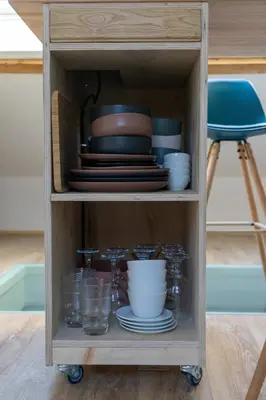 a cabinet with plates and bowls and dishes at Au petit Marius in Cannes