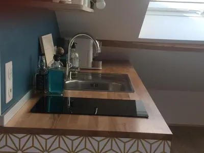 a kitchen counter with a sink and a window at Au petit Marius in Cannes